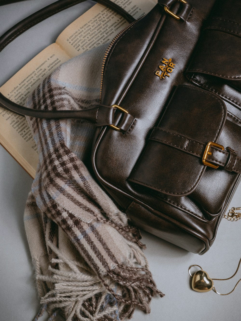 Brown bag on an open book — reference styling photo